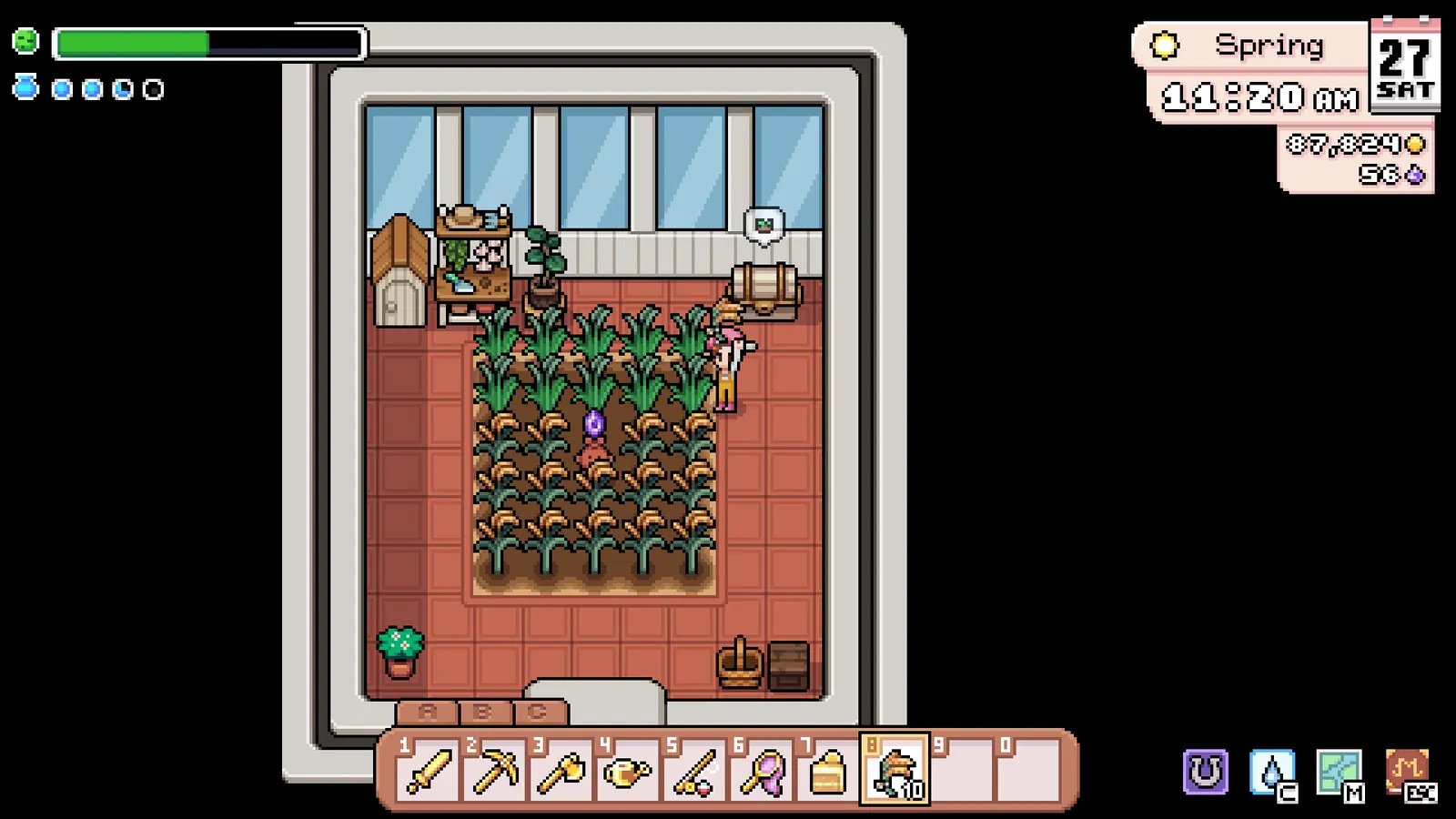 Screenshot of crops growing in planting boxes inside a greenhouse in Fields of Mistria